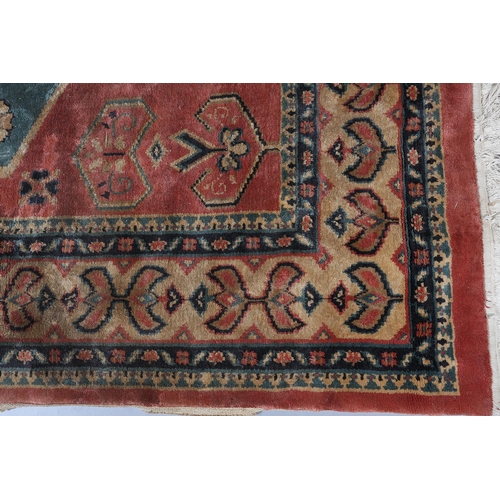 106 - A Caucasian silk carpet, the coral field having a turquoise and coral medallion with geometric motif... 