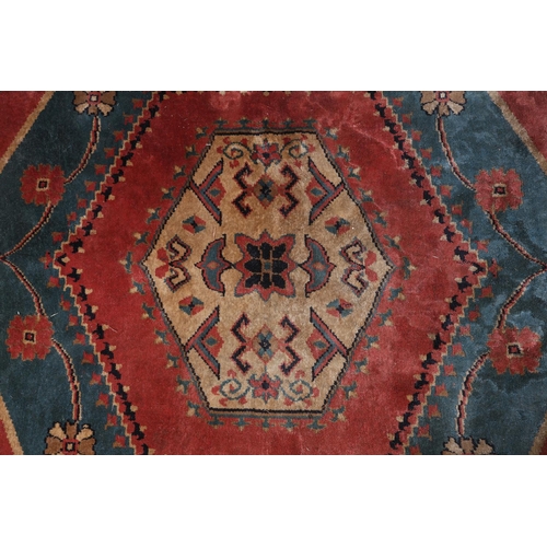 106 - A Caucasian silk carpet, the coral field having a turquoise and coral medallion with geometric motif... 