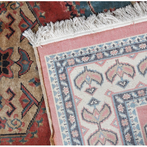 106 - A Caucasian silk carpet, the coral field having a turquoise and coral medallion with geometric motif... 