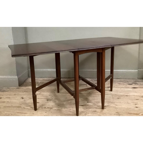 128 - A 1970's mahogany drop leaf dining table on rounded legs