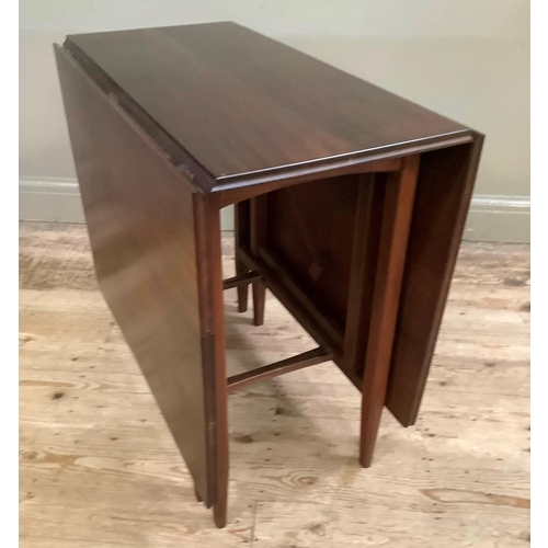 128 - A 1970's mahogany drop leaf dining table on rounded legs