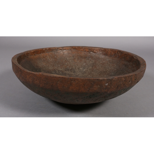 52 - A large rough-hewn carved hardwood bowl, 23cm high x 66.5cm diameter