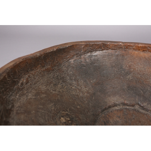 52 - A large rough-hewn carved hardwood bowl, 23cm high x 66.5cm diameter