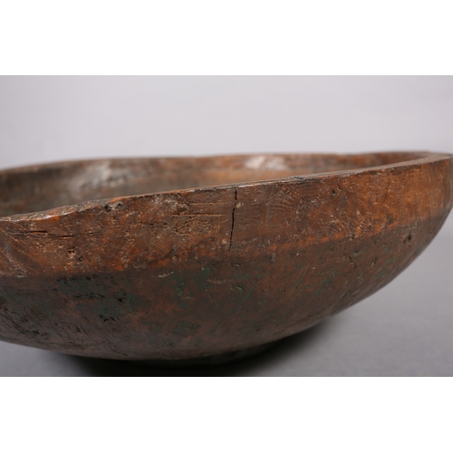 52 - A large rough-hewn carved hardwood bowl, 23cm high x 66.5cm diameter