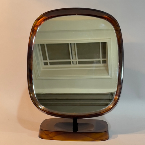 99 - A Danish plastic faux tortoiseshell dressing table mirror on a dished pedestal base 28cm wide x 36.5... 