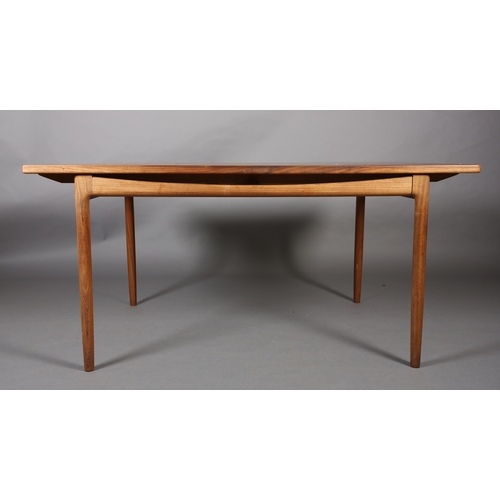 74 - A 1970's teak and walnut extending dining table, rectangular, on rounded and tapered legs, 89cm wide... 