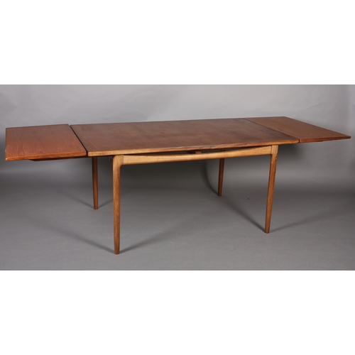 74 - A 1970's teak and walnut extending dining table, rectangular, on rounded and tapered legs, 89cm wide... 