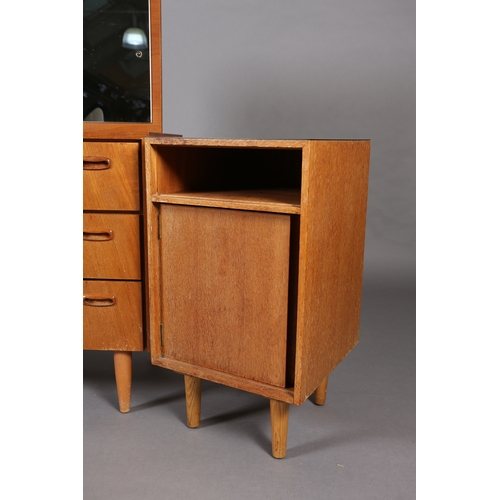 83 - A Stag teak and mirrored dressing chest of three drawers and a black Formica topped bedside cupboard... 