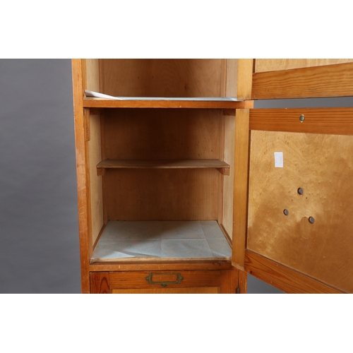 41 - A set of four vertical pine and plywood lockers mid 20th century each with brass window plate, on pl... 