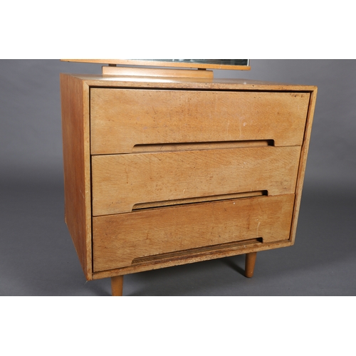 84 - An early 1970s beech and mirrored dressing chest of three drawers on rounded and tapered legs, 76cm ... 