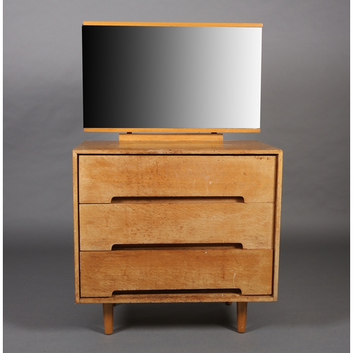 84 - An early 1970s beech and mirrored dressing chest of three drawers on rounded and tapered legs, 76cm ... 