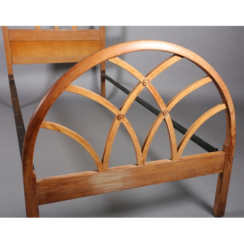 101 - A mid 20th century elm single bed stead by Hypnos, the head and footboard of open semi-circular trel... 