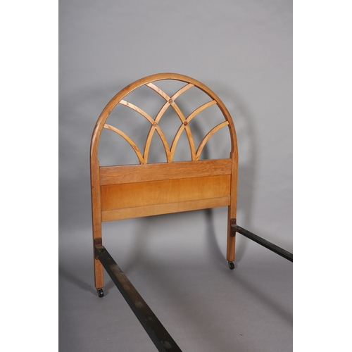 101 - A mid 20th century elm single bed stead by Hypnos, the head and footboard of open semi-circular trel... 