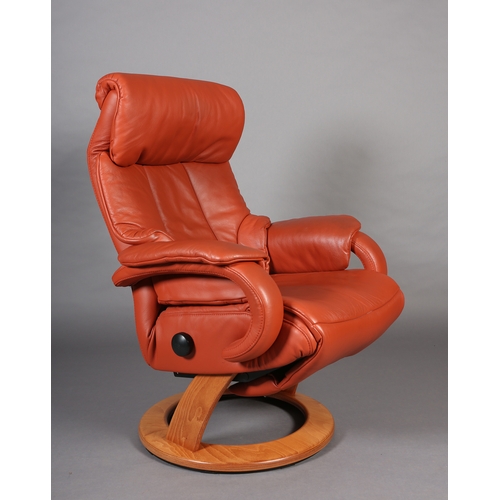 44 - A Himolla swivel armchair upholstered in terracotta coloured leather