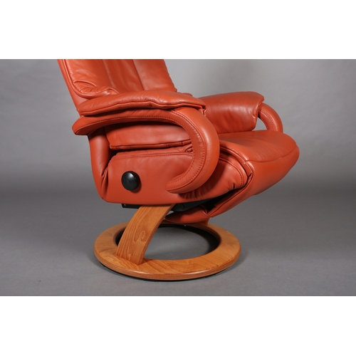 44 - A Himolla swivel armchair upholstered in terracotta coloured leather