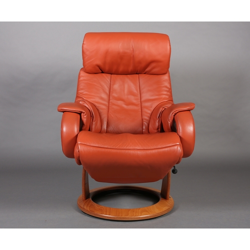 44 - A Himolla swivel armchair upholstered in terracotta coloured leather