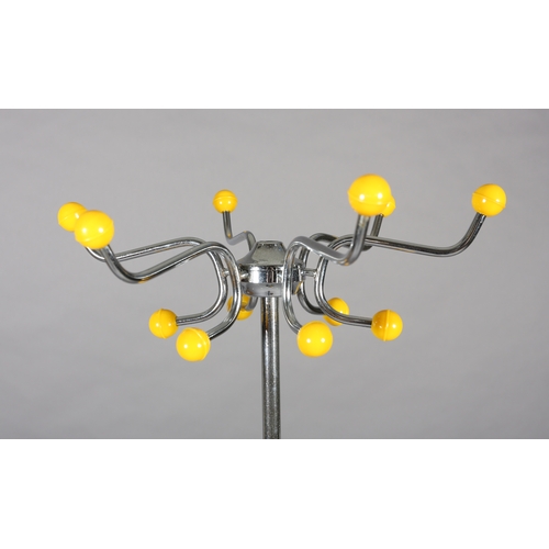 29 - A 1960s polished steel, yellow and black plastic hat and coat stand together with a white wire work ... 