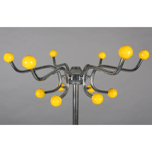 29 - A 1960s polished steel, yellow and black plastic hat and coat stand together with a white wire work ... 