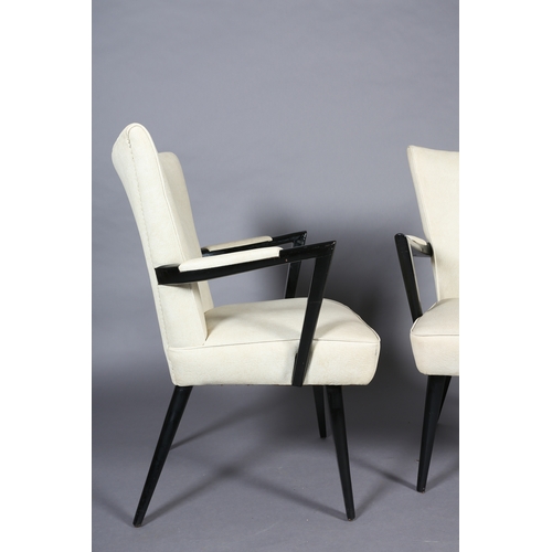 31 - A pair of 1950s black framed cocktail lounge chairs upholstered in cream PVC