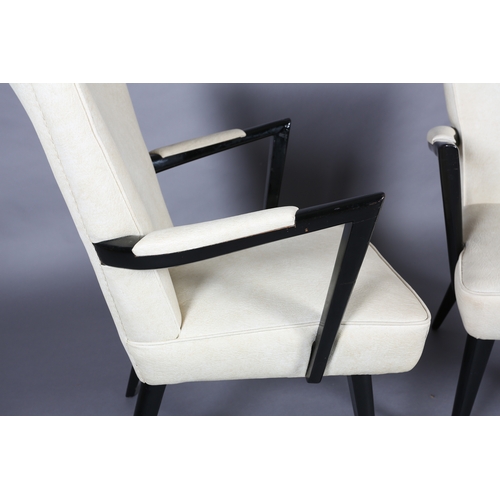 31 - A pair of 1950s black framed cocktail lounge chairs upholstered in cream PVC