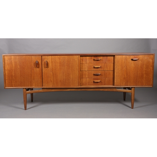 76 - A G Plan 'Brasilia' teak sideboard having a two door cupboard, four drawers and a drop front cupboar... 