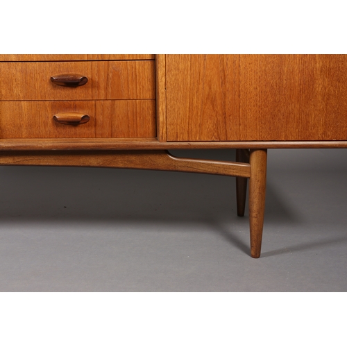 76 - A G Plan 'Brasilia' teak sideboard having a two door cupboard, four drawers and a drop front cupboar... 