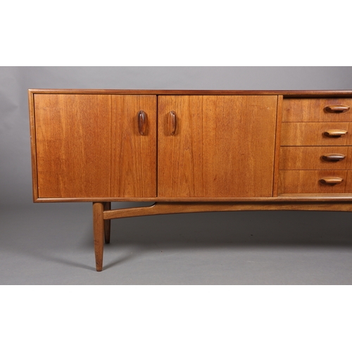 76 - A G Plan 'Brasilia' teak sideboard having a two door cupboard, four drawers and a drop front cupboar... 