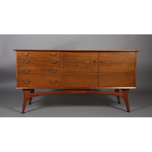 114 - Alfred Cox, A walnut sideboard 1950s having four graduated drawers with gilt metal swing handles fla... 