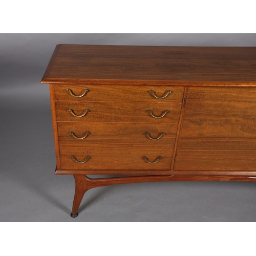 114 - Alfred Cox, A walnut sideboard 1950s having four graduated drawers with gilt metal swing handles fla... 