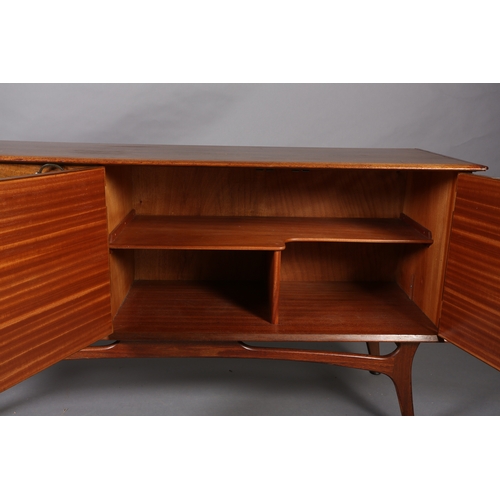 114 - Alfred Cox, A walnut sideboard 1950s having four graduated drawers with gilt metal swing handles fla... 