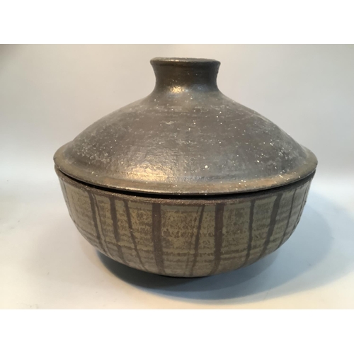 68 - A stoneware pot and cover with dripped brown glaze together with an eastern woven basket with lid