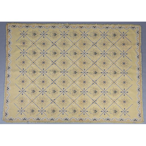 54 - A mid century needlwork tapestry style rug with blue squares containing florettes on a mustard groun... 