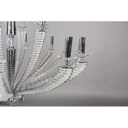 63 - A two tier white metal chandelier of eighteen lights, radiating from a central column, each arm stru... 