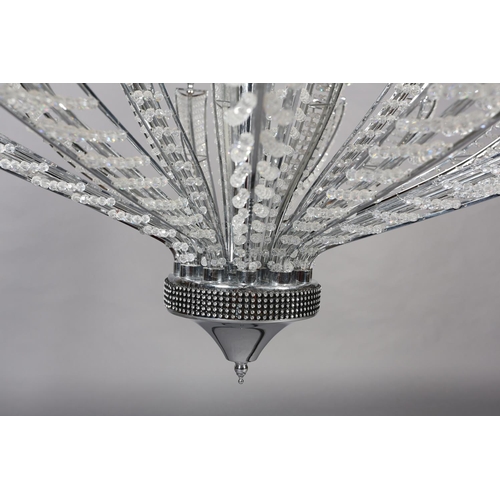 63 - A two tier white metal chandelier of eighteen lights, radiating from a central column, each arm stru... 