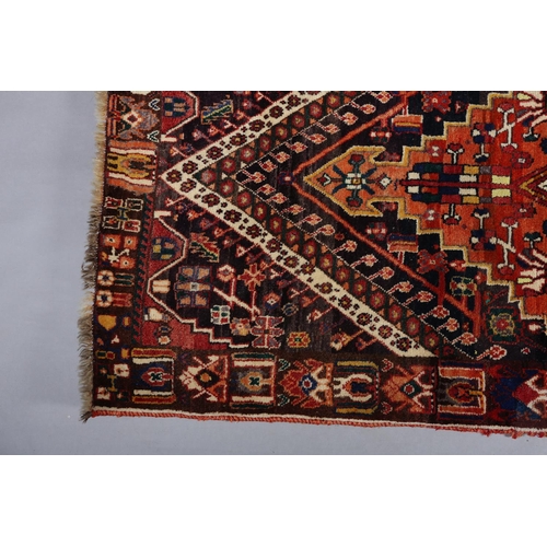 105 - A Middle Easton carpet, the aubergine ground having an off-set lozenge filled with a cruciform, styl... 