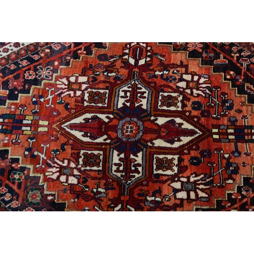 105 - A Middle Easton carpet, the aubergine ground having an off-set lozenge filled with a cruciform, styl... 