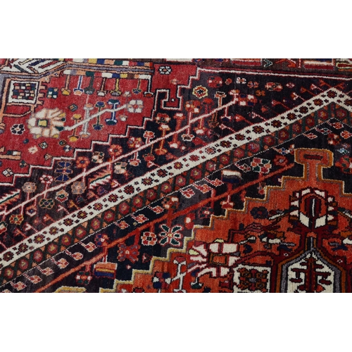 105 - A Middle Easton carpet, the aubergine ground having an off-set lozenge filled with a cruciform, styl... 