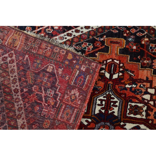 105 - A Middle Easton carpet, the aubergine ground having an off-set lozenge filled with a cruciform, styl... 