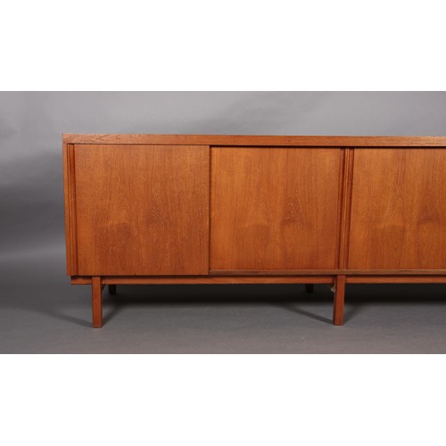 73 - An afromosia sideboard by Fyne Lady of Banbury, having four sliding doors, fitted with five drawers ... 