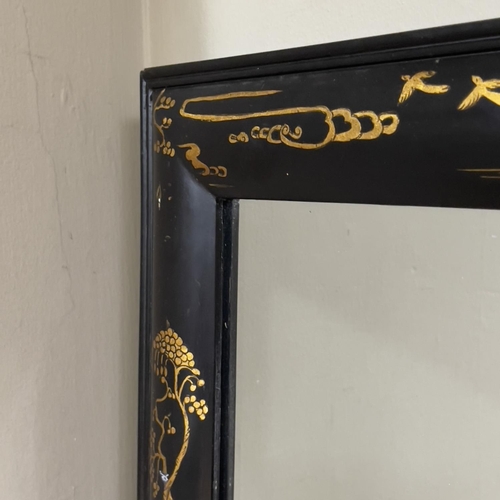 110 - A black lacquered and gilt chinoiserie wall mirror, rectangular, 64cm x 83cm