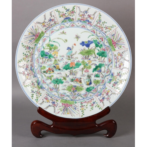 17 - A Chinese famille rose charger, painted to the centre with water fowl amongst lily pads with a wavy ... 