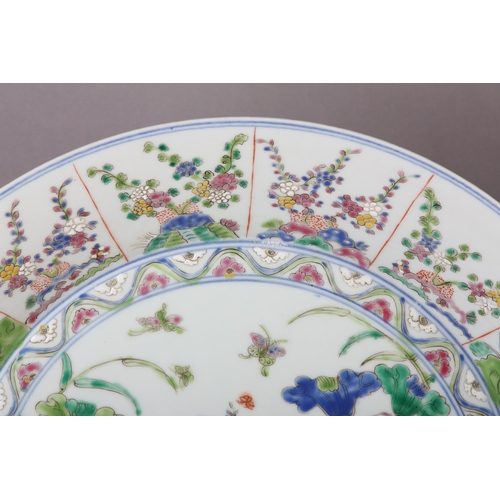 17 - A Chinese famille rose charger, painted to the centre with water fowl amongst lily pads with a wavy ... 