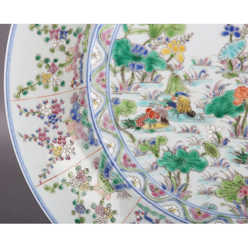 17 - A Chinese famille rose charger, painted to the centre with water fowl amongst lily pads with a wavy ... 