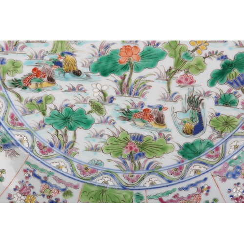 17 - A Chinese famille rose charger, painted to the centre with water fowl amongst lily pads with a wavy ... 