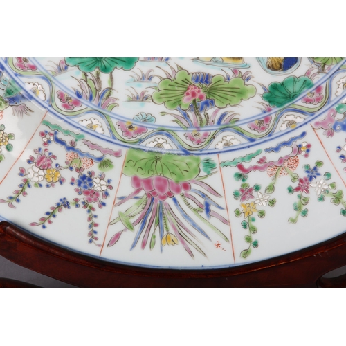 17 - A Chinese famille rose charger, painted to the centre with water fowl amongst lily pads with a wavy ... 