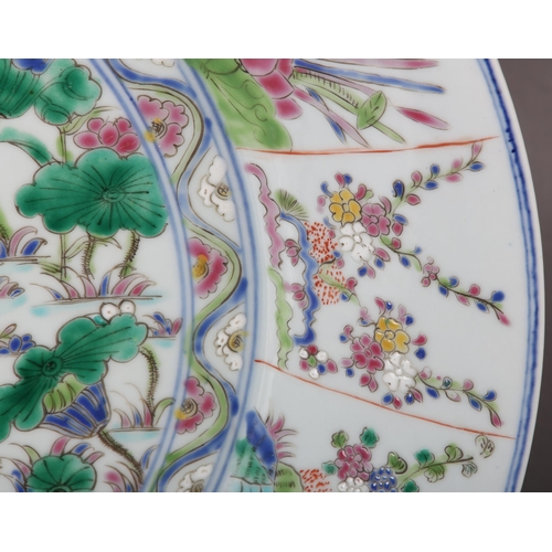 17 - A Chinese famille rose charger, painted to the centre with water fowl amongst lily pads with a wavy ... 