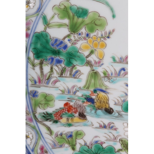 17 - A Chinese famille rose charger, painted to the centre with water fowl amongst lily pads with a wavy ... 