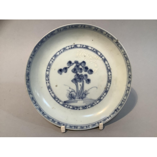 18 - A Nanking Cargo blue and white saucer dish painted rocks issuing pine branches within a circular bor... 