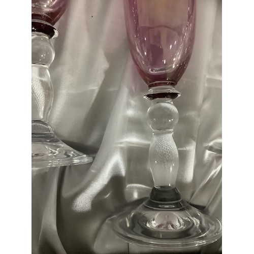 23 - A set of six amethyst Rockingham crystal flutes with gilt banding