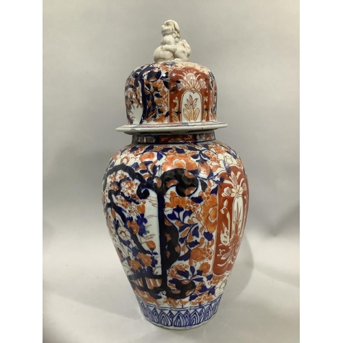 25 - A Japanese Imari vase and cover, the fluted body painted in the typical Imari palette, having a dome... 